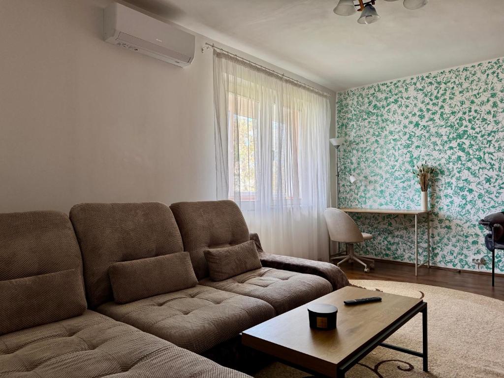 a living room with a couch and a table at Your cozy place in Târgu-Mureş