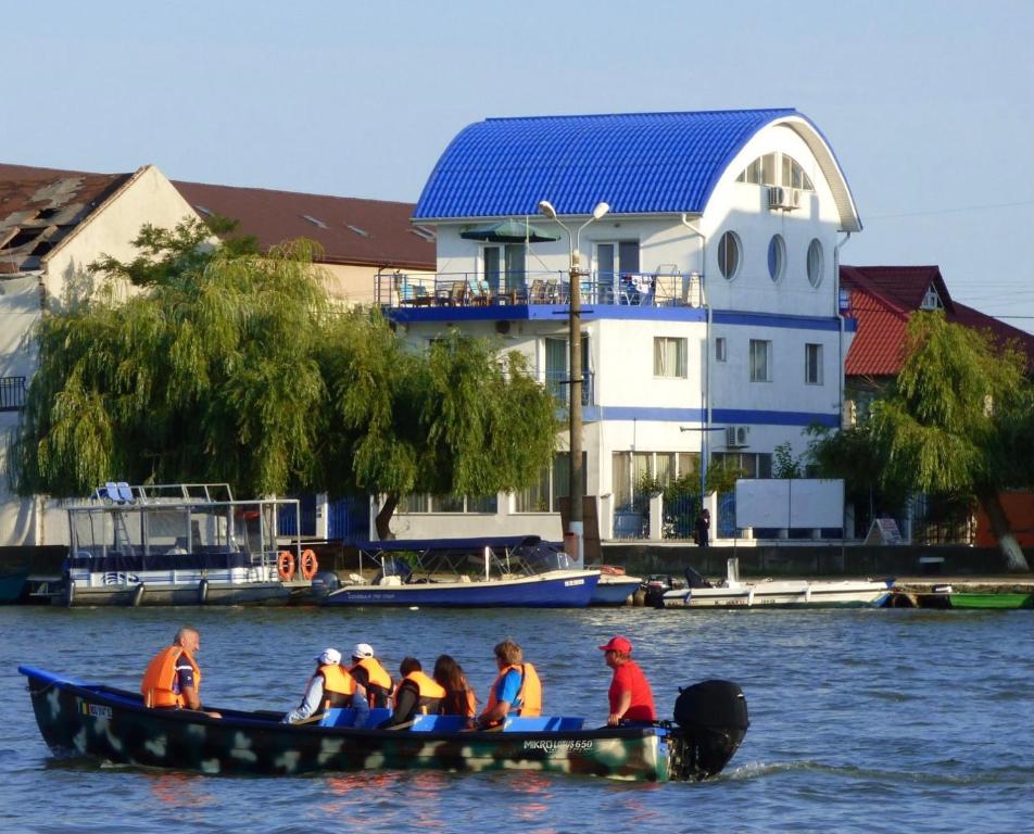 a group of people in a boat on the water at Marina House in Sulina