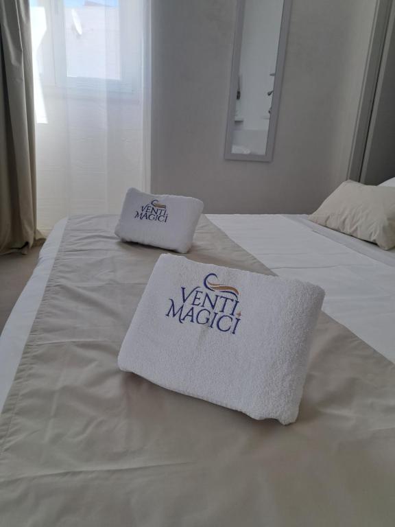 a white bed with two pillows on top of it at Venti Magici Rooms in Peschici