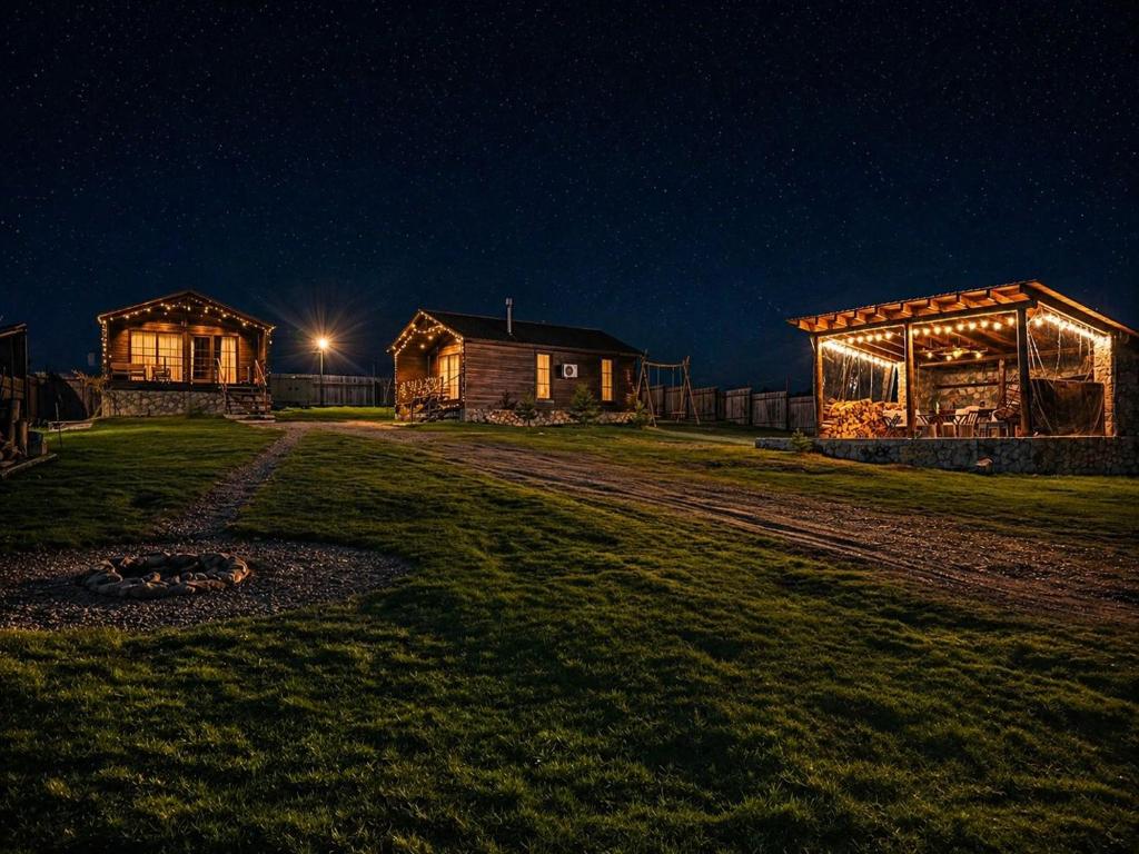 a couple of barns at night with lights at Mestia Villas in Mestia