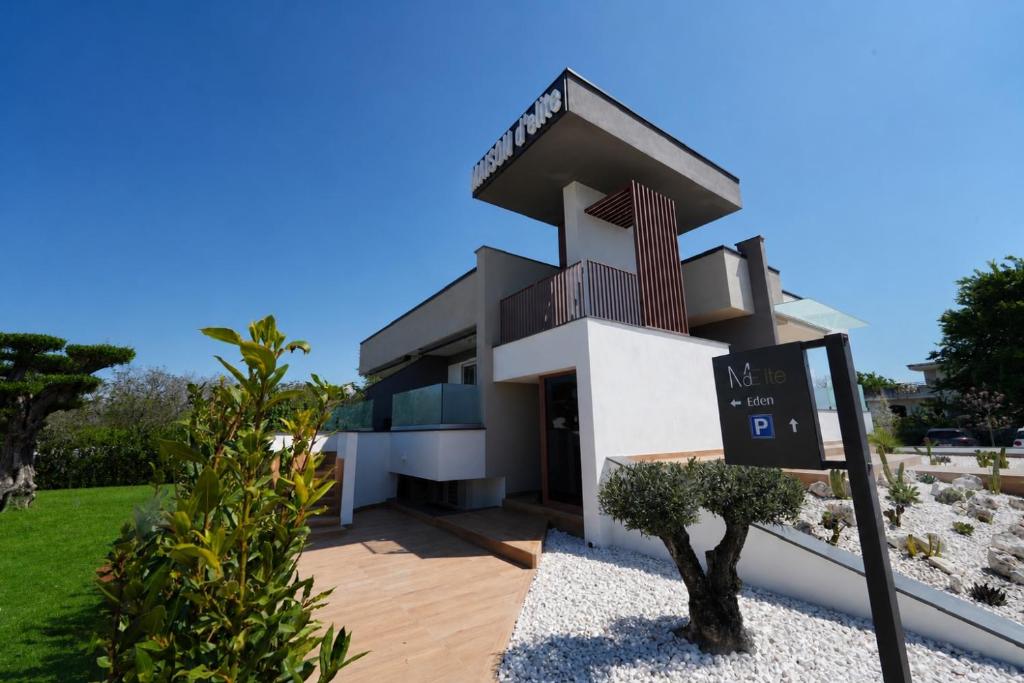 a house with a sign in front of it at Maison d'Elite in Marigliano