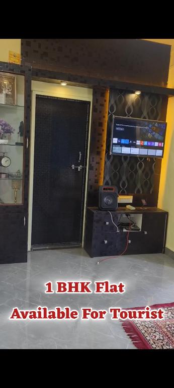 a door to a room with a computer and a monitor at Siddhi Home Stay in Kolhapur