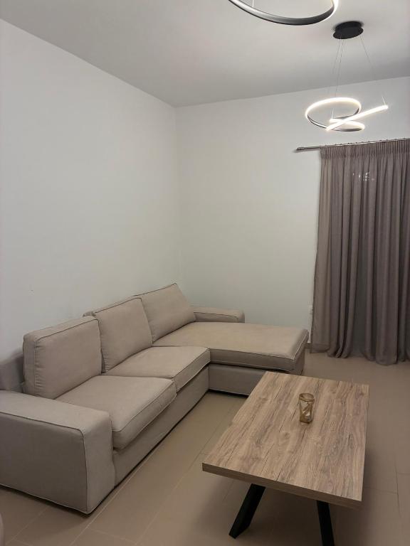 a living room with a couch and a coffee table at Nenes Comfort Apartment in Koroni