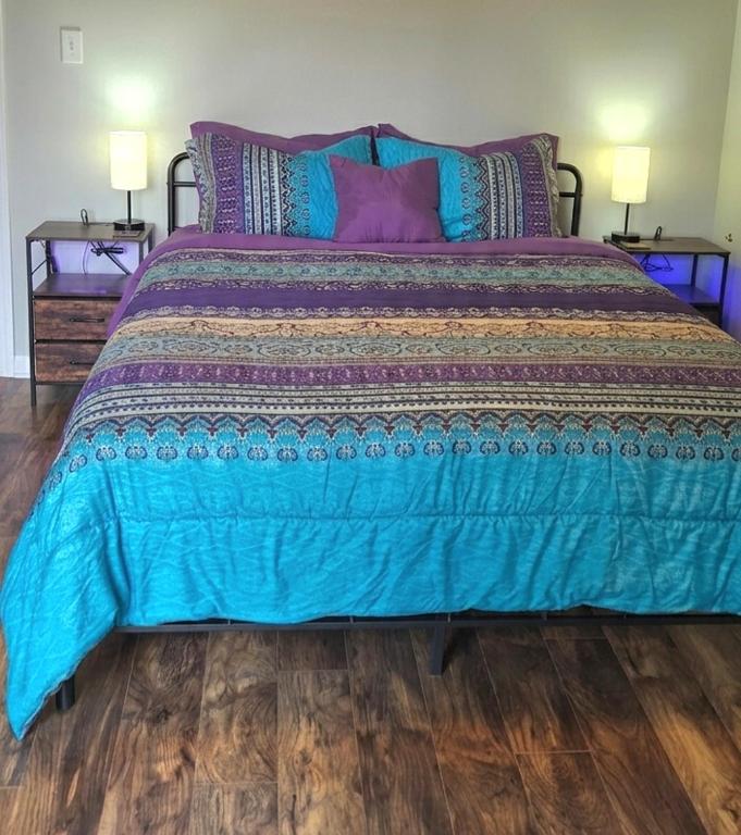 a large bed with a blue comforter in a bedroom at Tiny Palace - 1-Bedroom Apartment - Multi-Week Stay - Pool - Washer-Dryer - Dog-friendly with fee for 1 Family Pet in Wilmington