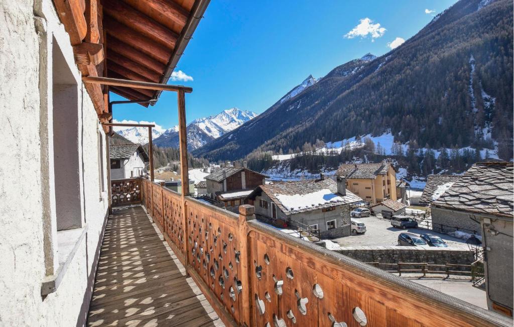 a balcony with a view of a town and mountains at Amazing Apartment In Cogne in Cogne