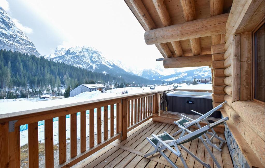 a balcony with a view of a snow covered mountain at Gorgeous Home In Sappada With Sauna in Sappada
