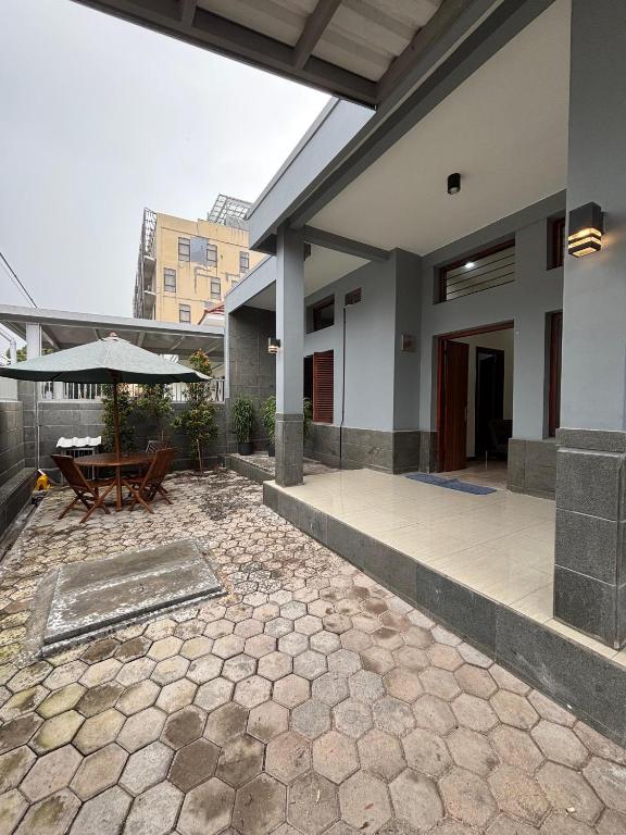 an outdoor patio with a table and an umbrella at Base Seven Hostel in Bandung