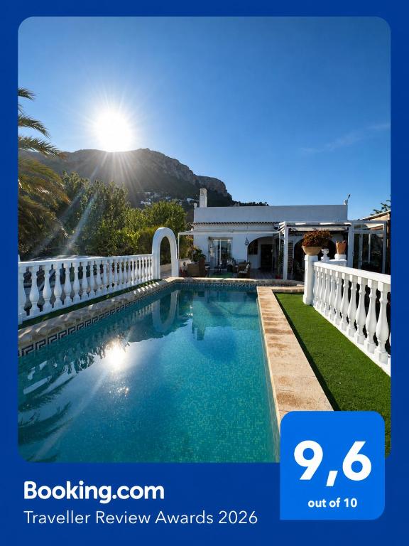 a swimming pool in front of a house at Villa Corralets Calpe in Calpe
