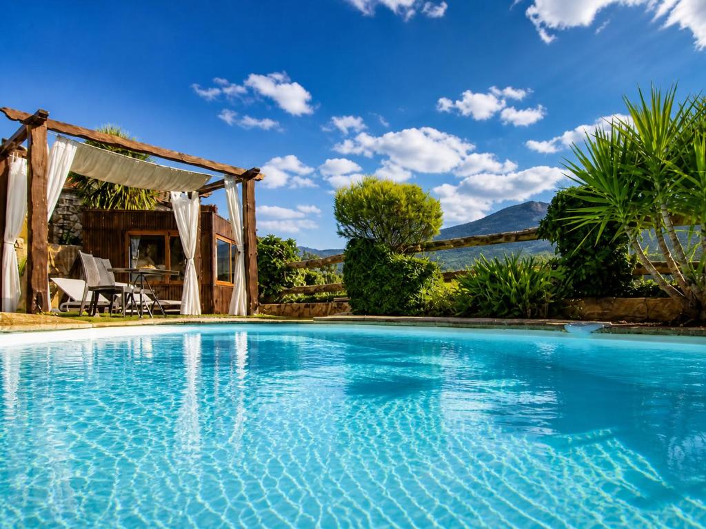 a swimming pool in a villa with a blue sky at Casa Love Story - Piscina, Sauna & Jacuzzi in Arcos de Valdevez