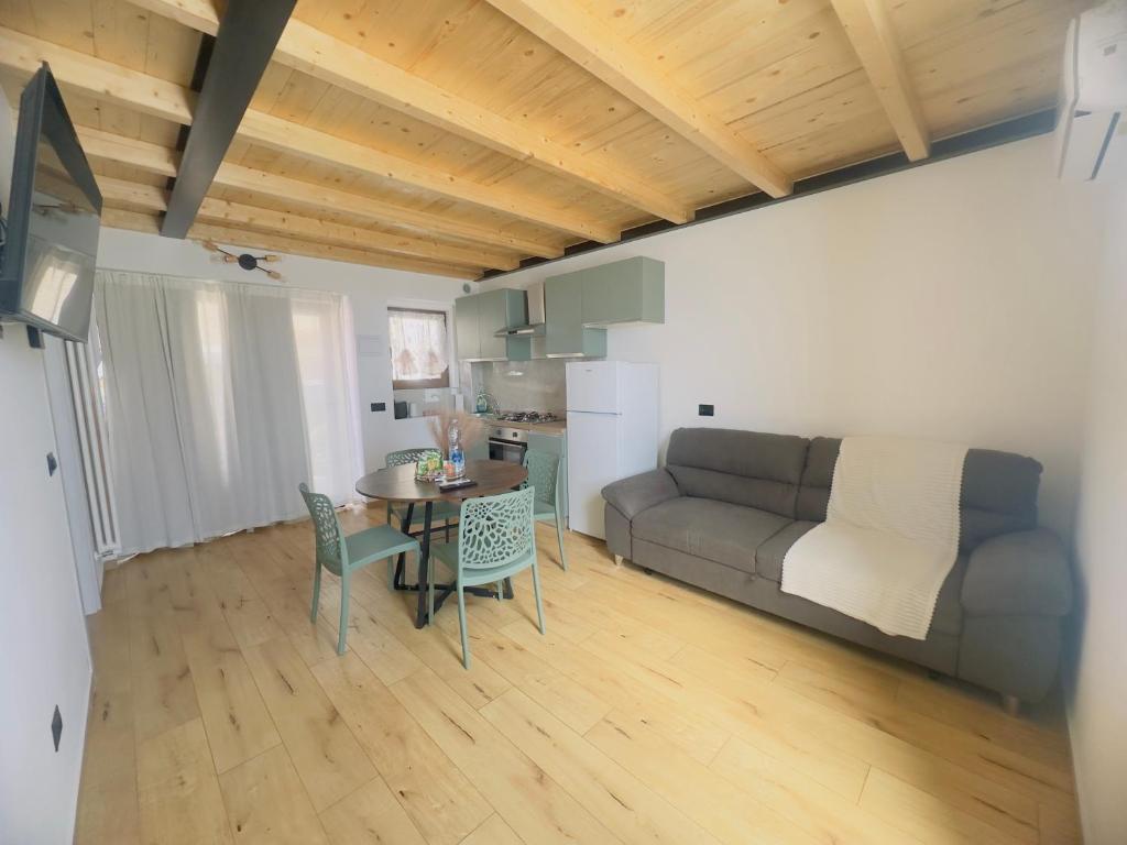 a living room with a couch and a table and chairs at La Casa Rossa II in Verona