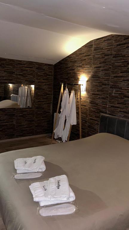 a room with a bed with white towels on it at Love room in La Celle-sous-Gouzon