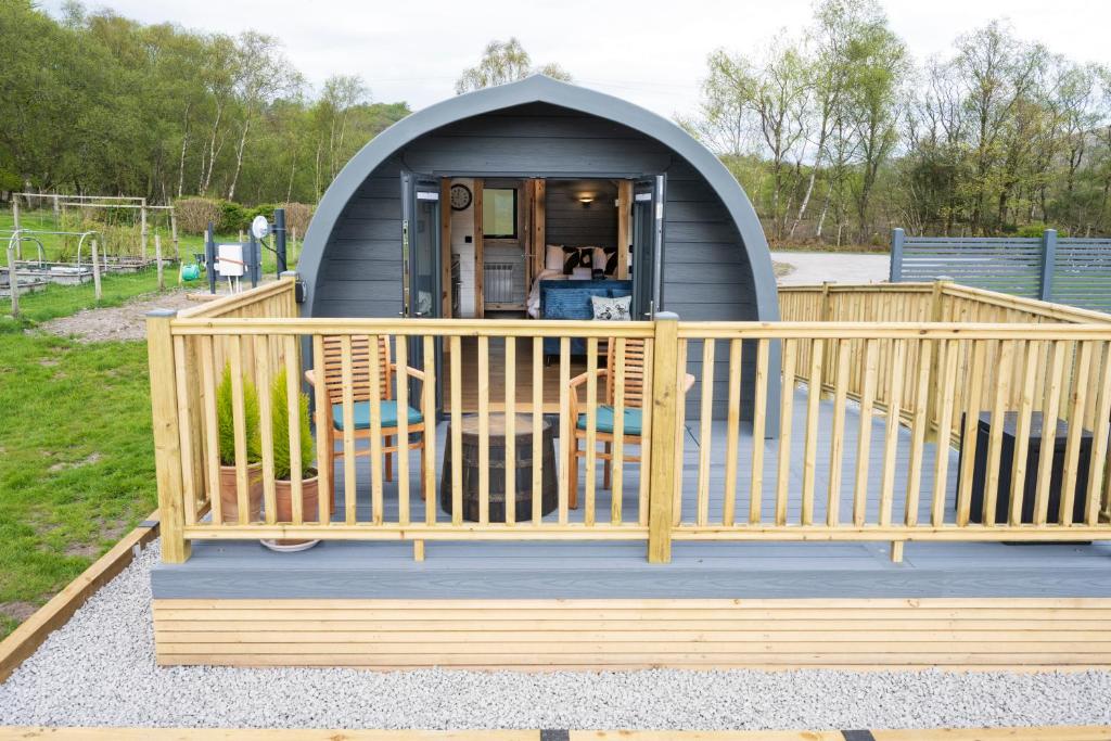 a gazebo with a porch and a deck at Appin's Coorie Nook in Appin