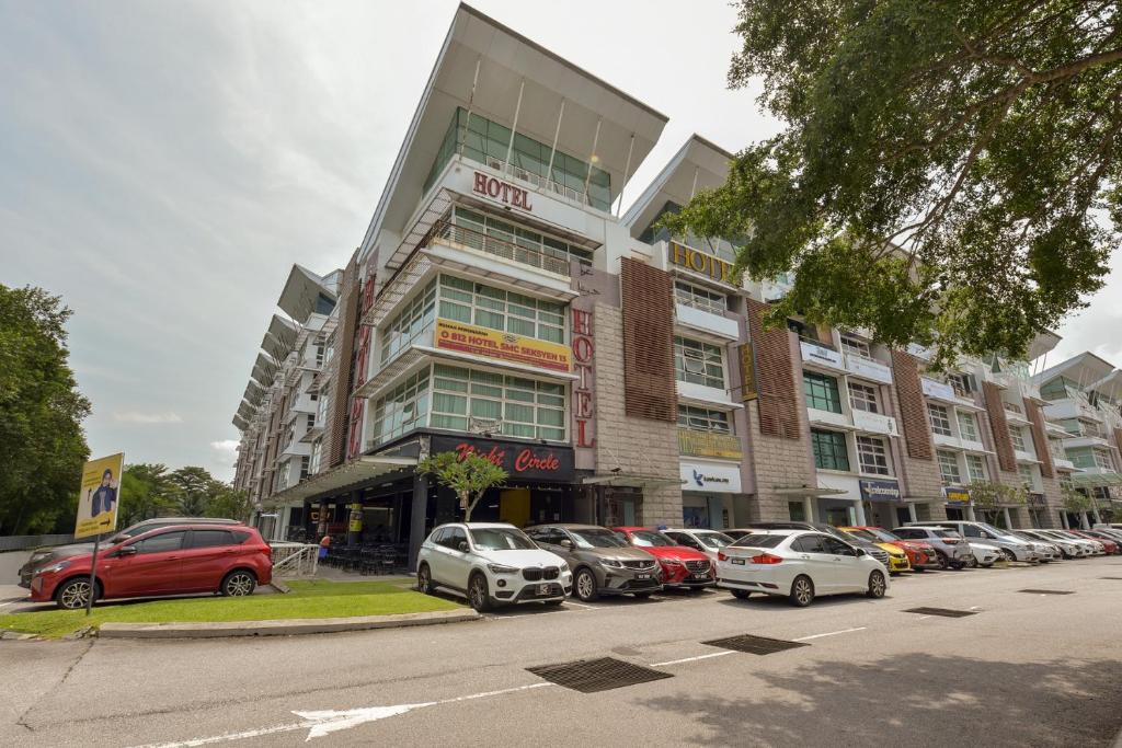 a parking lot with cars parked in front of a building at SMC Hotel Seksyen 13 in Shah Alam