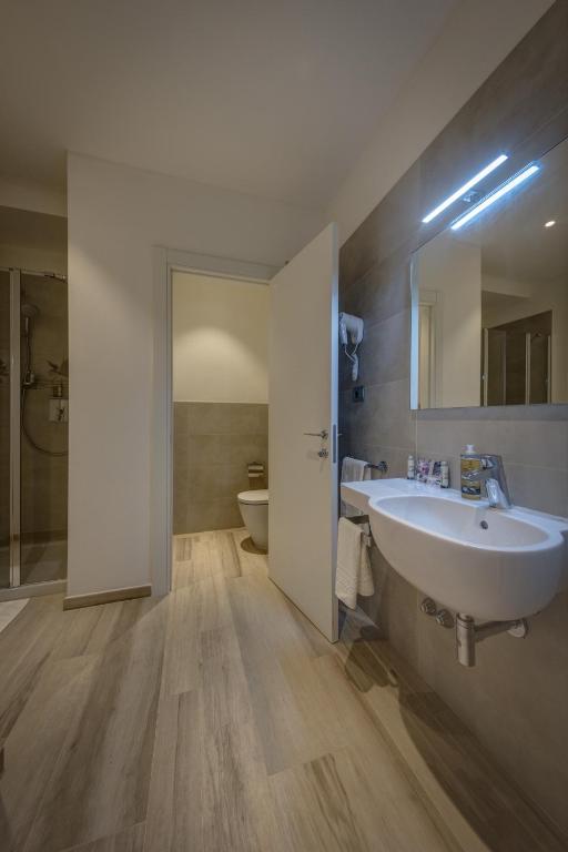 a bathroom with a white sink and a toilet at Arli Hotel Hideaway Punta Ala - Adults Only in Punta Ala