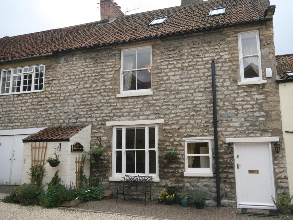 an old brick house with white doors and windows at The Old King's Head Pickering in Pickering
