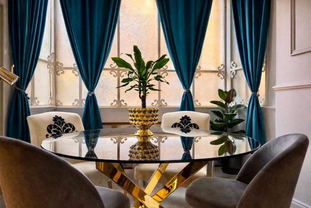 a dining room with a glass table and chairs at Spanish Steps Boutique Hotel - Madame Sofia Secret Hotel in Rome