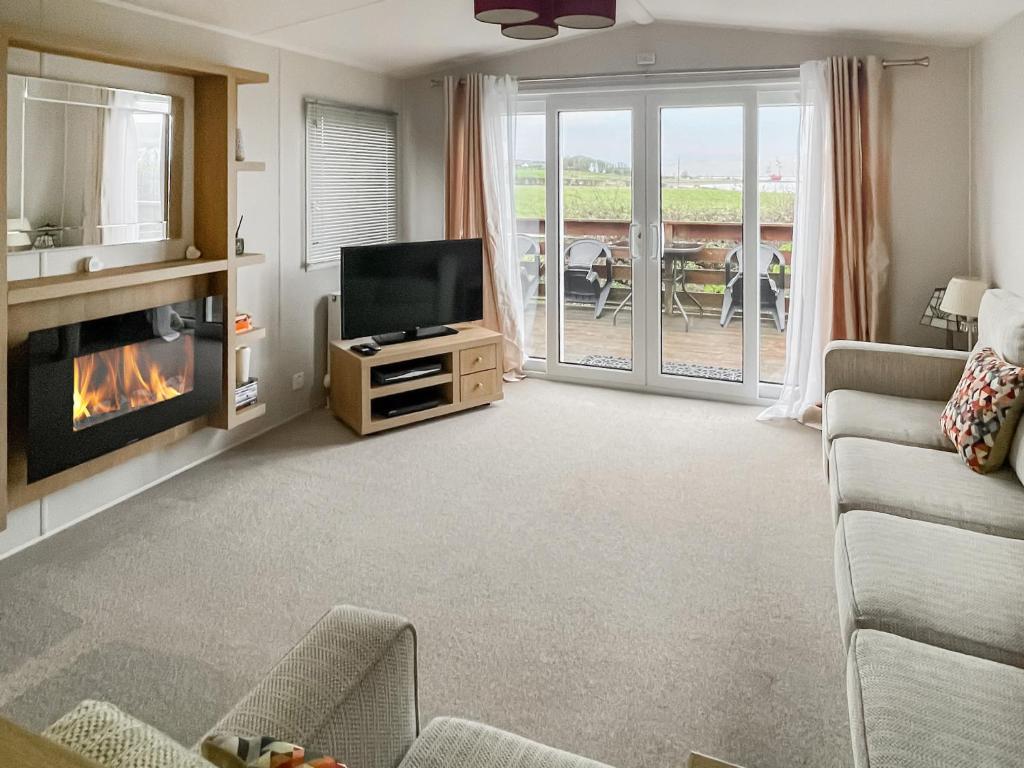 a living room with a tv and a fireplace at The View in Stranraer