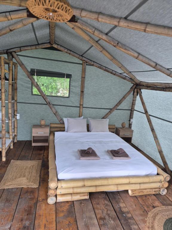 a bedroom with a bed in a tent at Bamboo glamping in Kotor