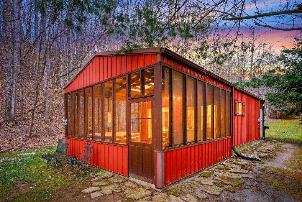 a red tiny house in the woods at Creekside Hideaway in Laurelville