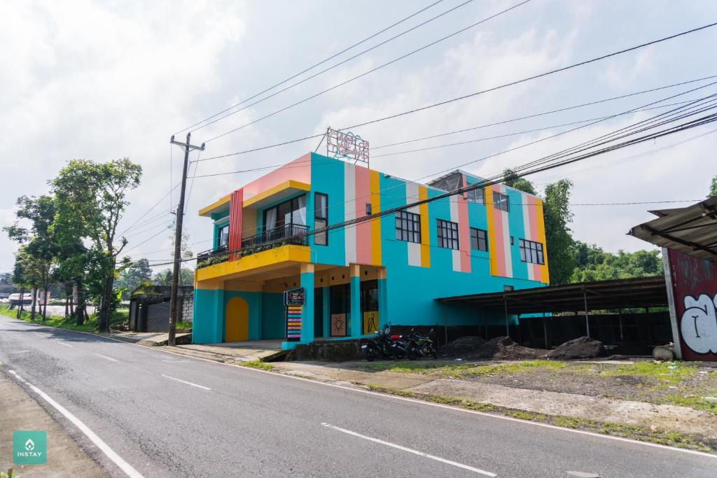 a colorful building on the side of a street at INSTAY Hotel Dieng Chill Serenity in Garung