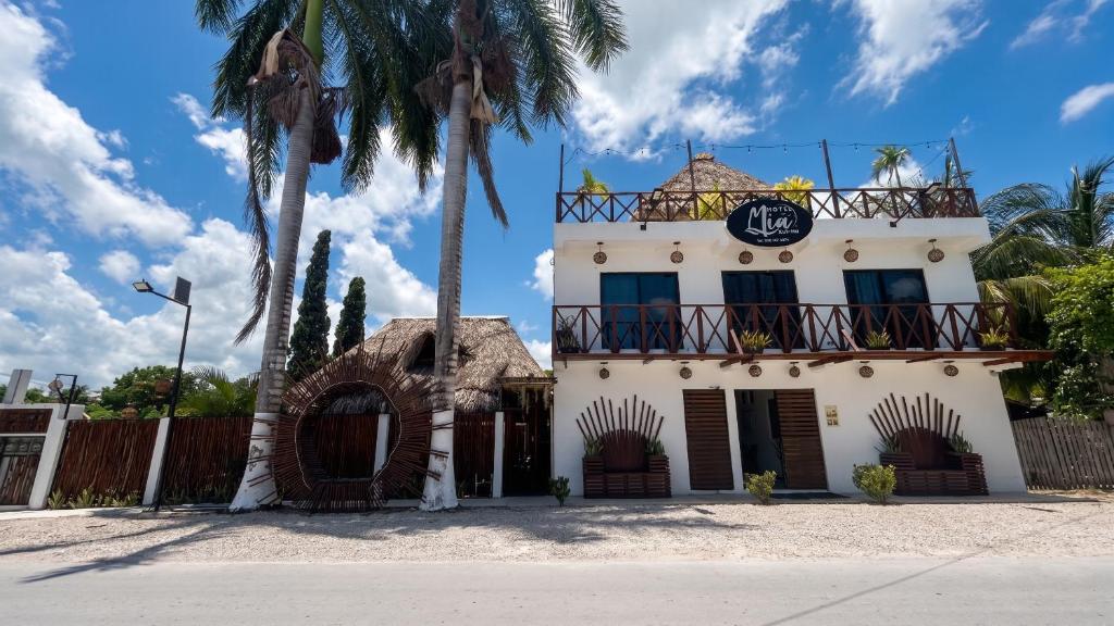 a building with a clock on the top of it at Hotel y Beach Club Casa Mia Xulha -Bacalar in Xul-Ha