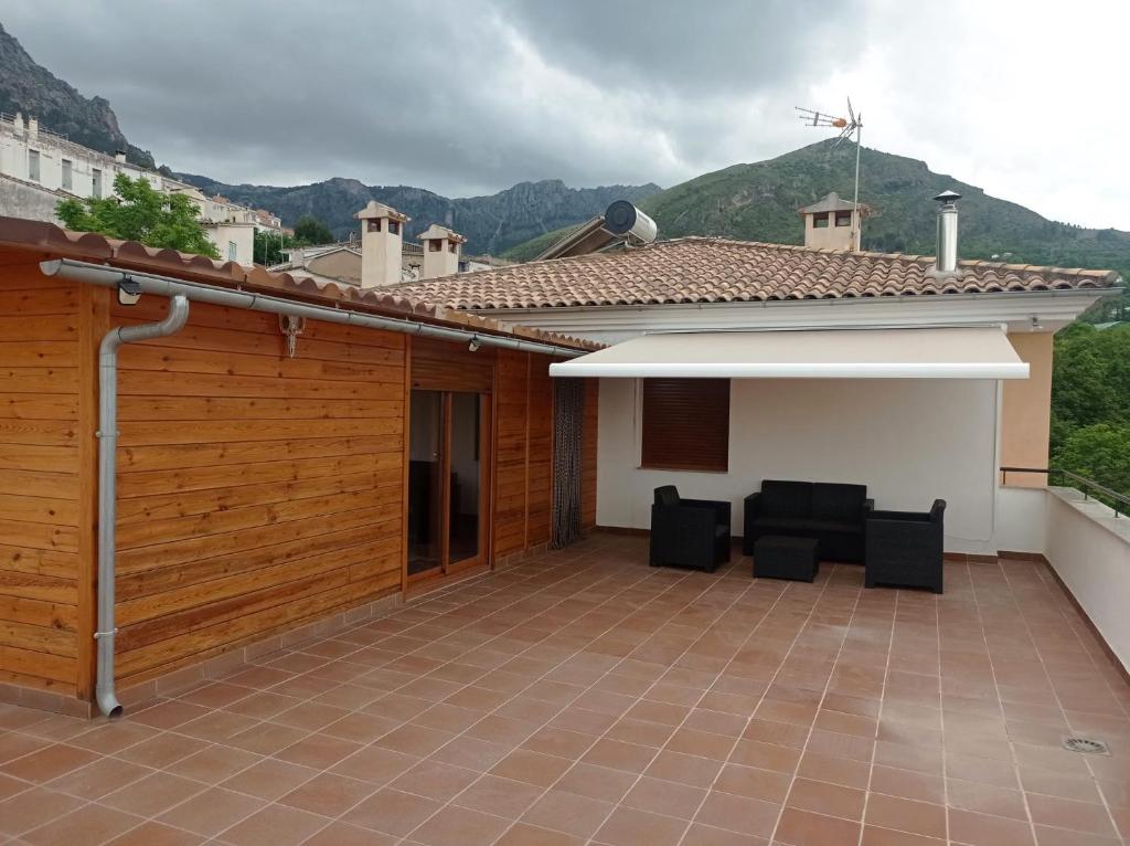 a patio of a house with two chairs on it at Casa Carmen in Cazorla