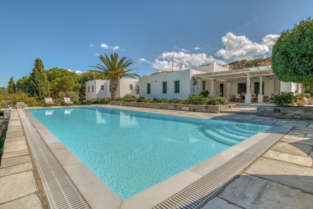 a swimming pool in front of a house at Villa Thimari in Protorgia
