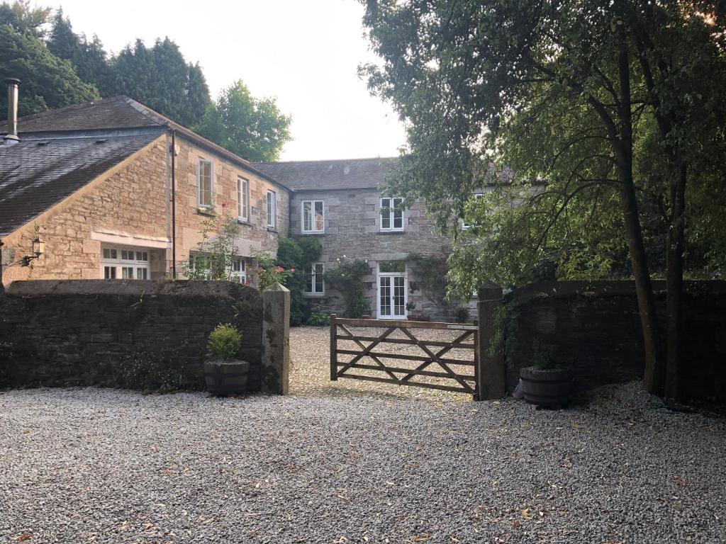 a gate in front of a house with a building at Tredrea Annexe - Self Contained Cornish hideaway in Truro