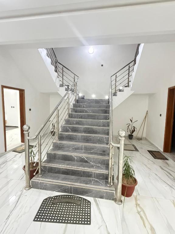 a staircase in a building with a metal railing at Dar AL-HANAA in Nouakchott