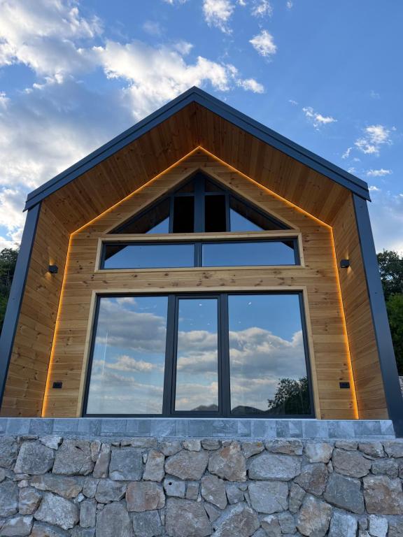 a large window on the front of a house at Stone Throne Retreat in Drušići
