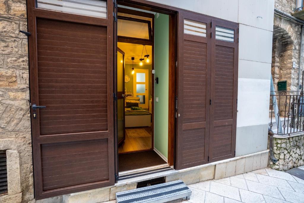 a building with wooden doors on the side at Minicasa Il Salone di Gino in Potenza