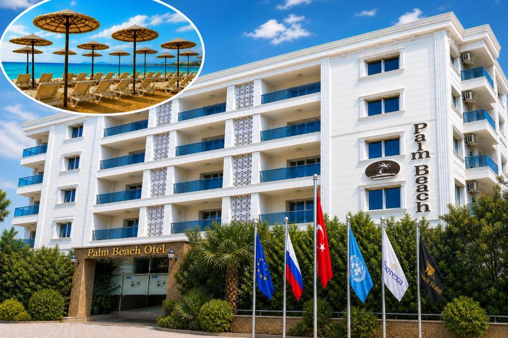 a hotel with chairs and umbrellas in front of it at Palm Beach Hotel in Silifke