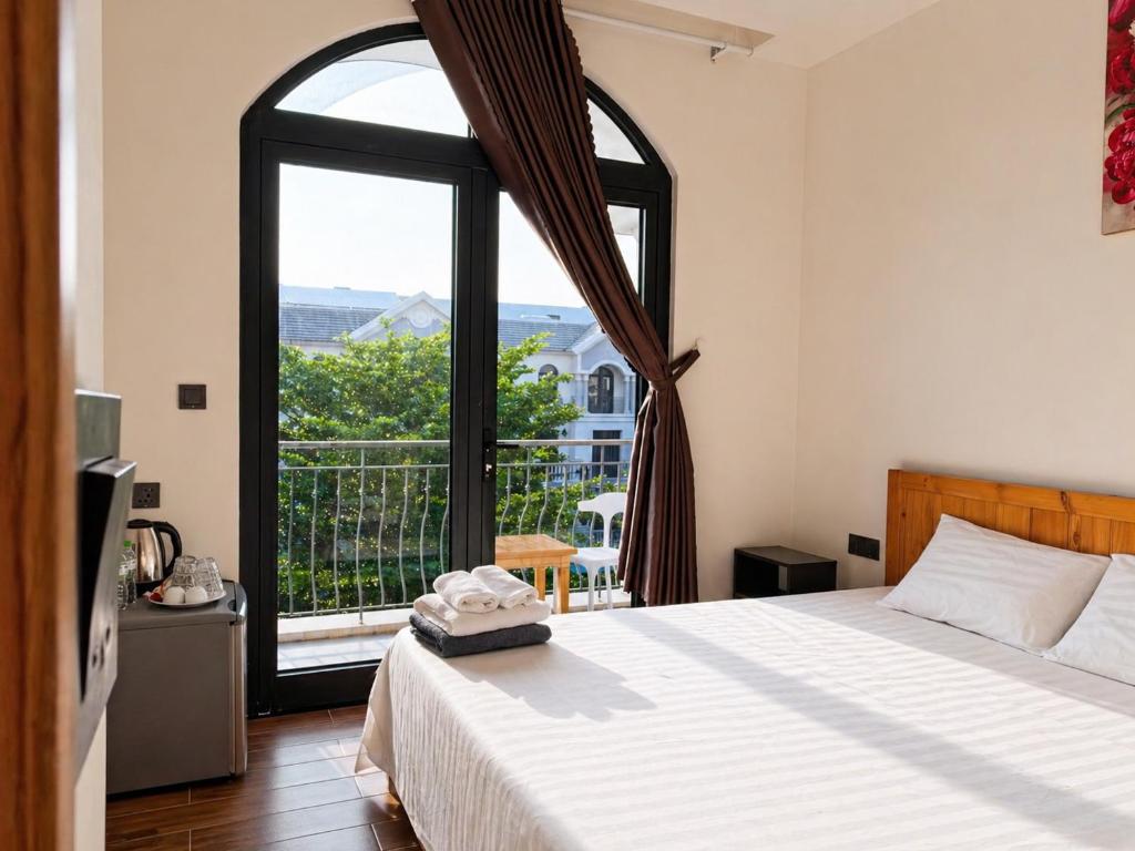 a bedroom with a bed and a large window at Lam Stay Grand World Phu Quoc in Phú Quốc