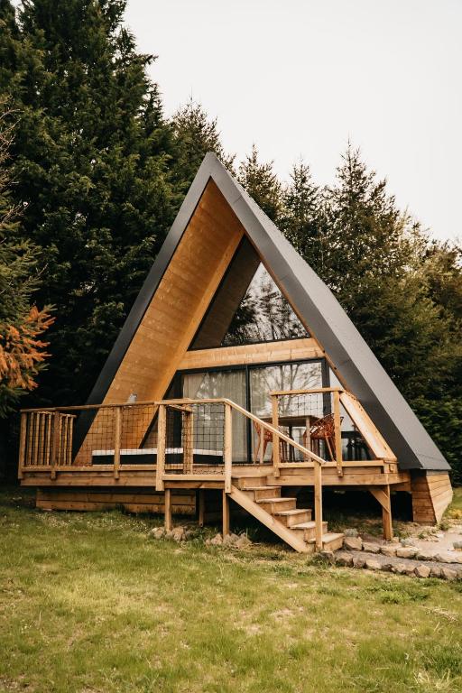 a small house with a gambrel roof at Les Terrasses du Grillon in Chambon-sur-Lac