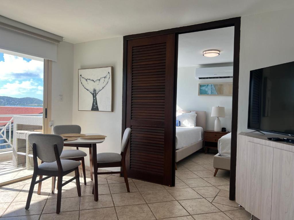 a room with a bed and a table and a television at Seaside Villa Culebra in Culebra