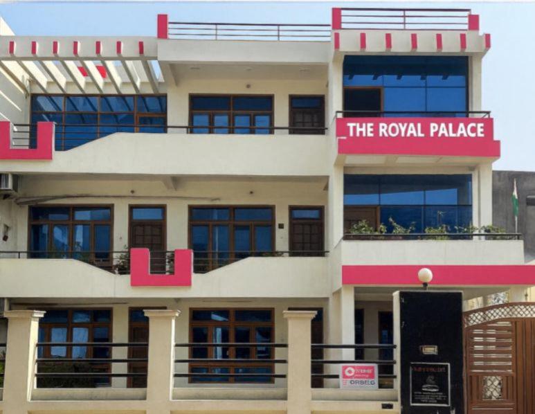 a large building with a sign that reads the royal palace at The Royal Palace in Lucknow