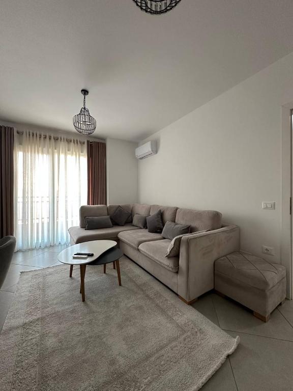 a living room with a couch and a table at Prime Rooms Tirana in Tirana