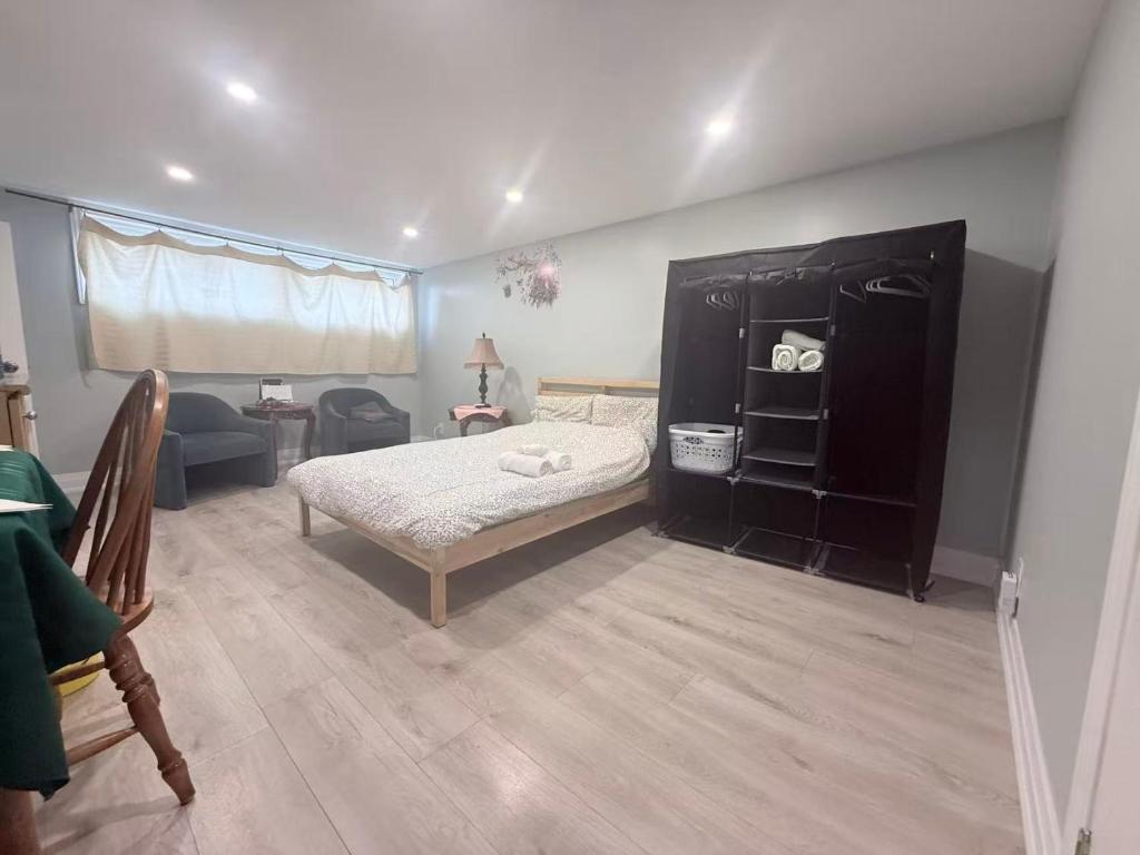 a bedroom with a bed and a black cabinet at Ideal Bachelor Suite For Couples in Aurora in Aurora