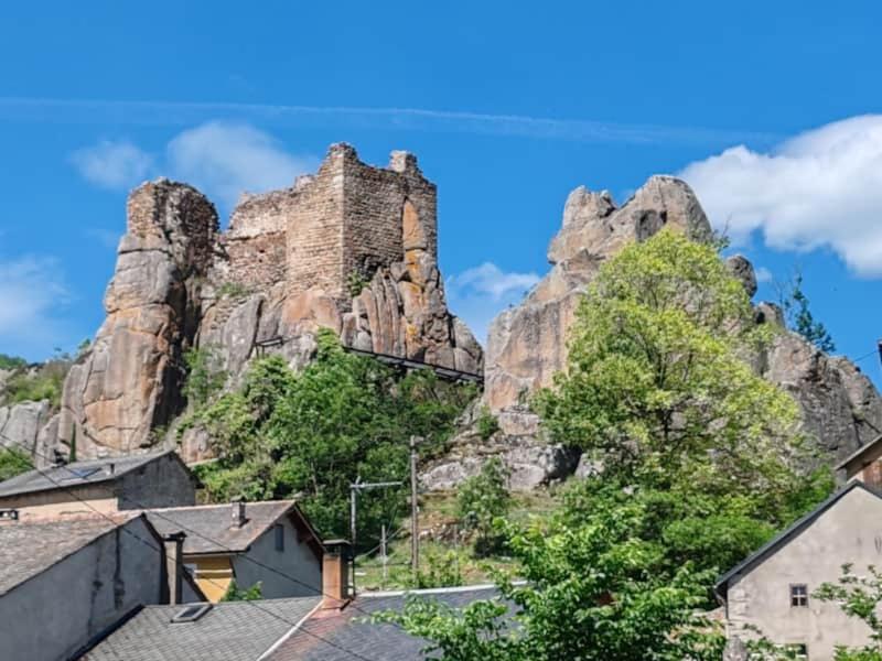 a castle on the side of a rocky mountain at L'Oursonnière de la Rende in Quérigut