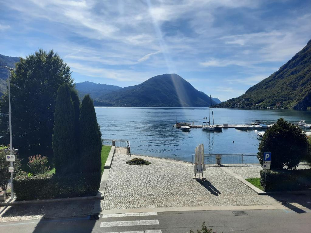 a view of a lake with boats in the water at La Rosa di Ilde in Porlezza