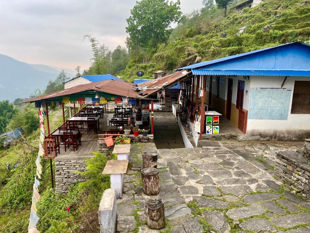 a building with tables and chairs on a mountain at Kimche Guest House in Astam