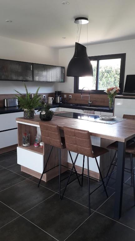 a kitchen with a large wooden table with chairs at Le Mans Changé GP 24H DU MANS in Changé