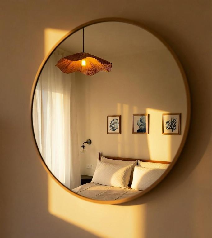 a bedroom with a bed and a mirror at Riva Viola in Alassio