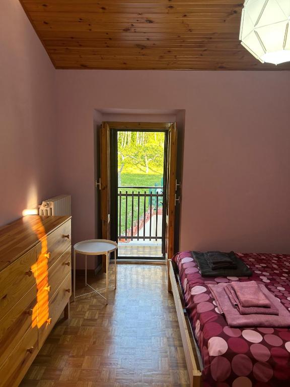 a bedroom with a bed and a door to a balcony at Casa Tritapepe in Torricella Peligna