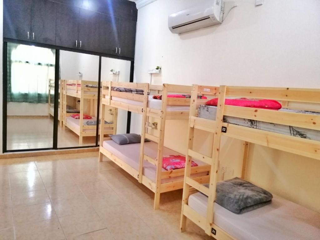 a group of bunk beds in a room at Home Line in Doha