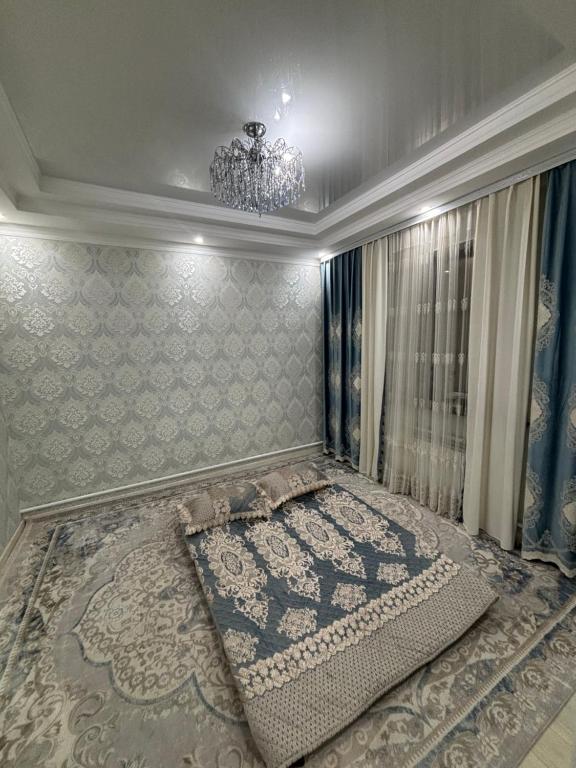 a bedroom with a bed with a chandelier at Starpath Homestay in At-Bashy