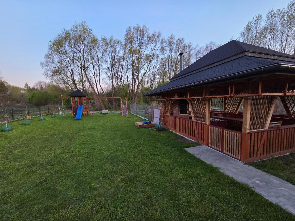 a pavilion with a playground in a park at Zacisze na Roztoczu in Horyniec
