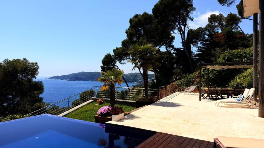 a swimming pool with a view of the water at Blueview Villa in Llafranc