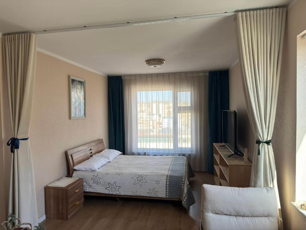a bedroom with a bed and a window at Miga's guest house & tour in Ulaanbaatar