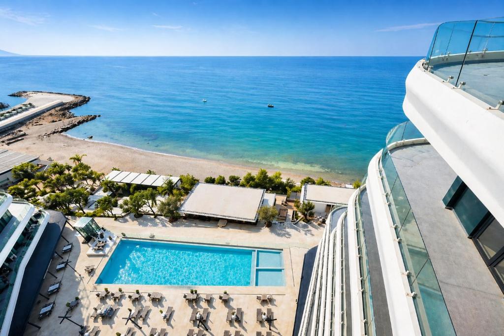 a view of the ocean from the balcony of a resort at Eddy's Luxury Suites - Ilyonis in Shëngjin